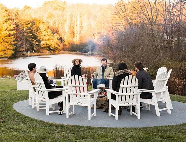 a group of people sitting around a fire pit