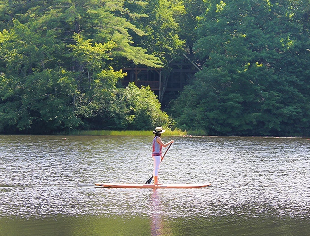 a person on a paddle board on a lake