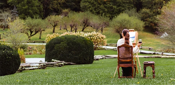 a woman sitting in a chair in a park