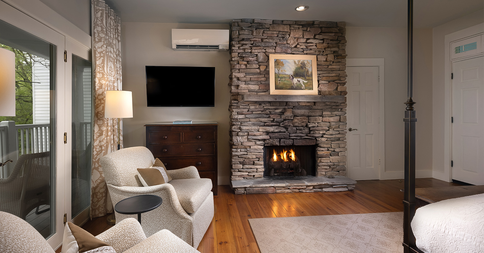 a living room with a fireplace and a tv