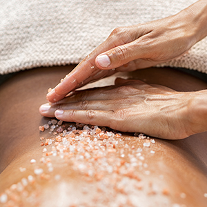 a person's hands massaging a body