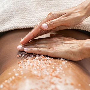 a person's hands massaging a body