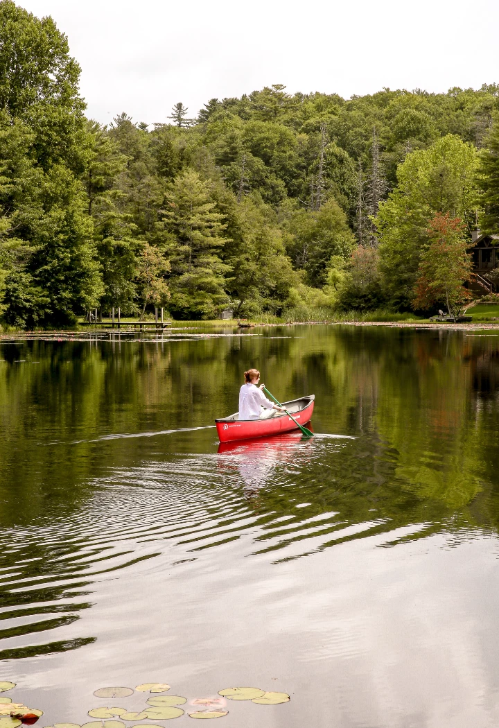 a person in a canoe on a lake