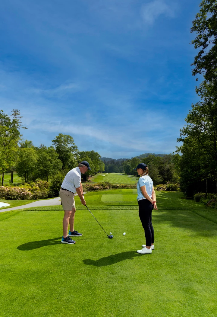 a man and woman playing golf
