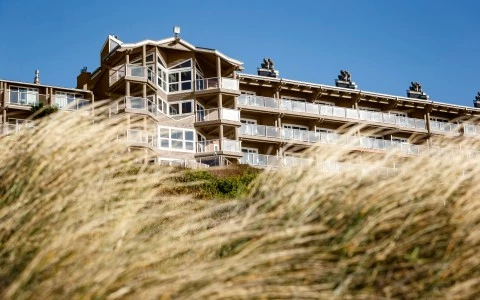 a building with balconies and grass