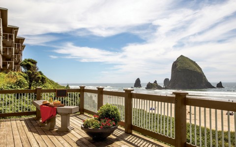 a deck with a view of the ocean and a beach
