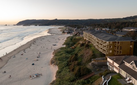 a beach with buildings and people on it