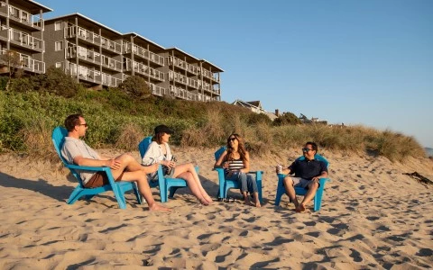 a group of people sitting in chairs on a beach