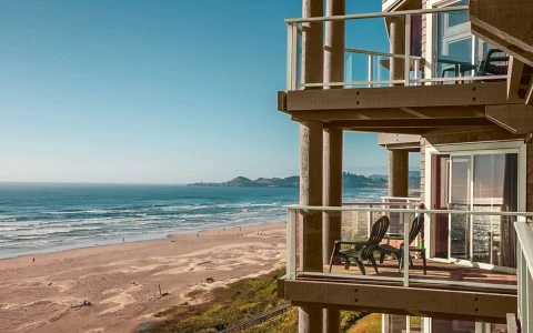 a beach with a deck and chairs