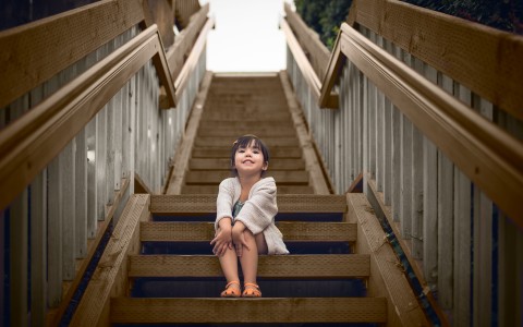 a girl sitting on a set of stairs