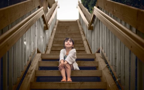 a girl sitting on a set of stairs