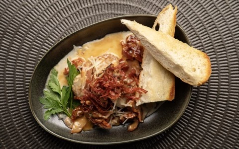 a bowl of food with bread and sauce