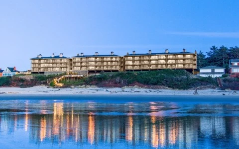 a building on a hill with a body of water