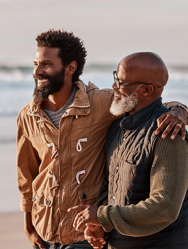 two men standing on a beach