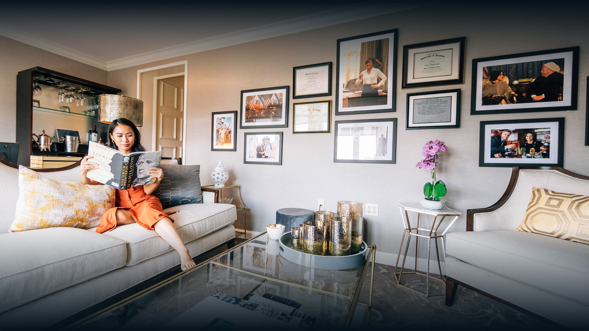 a person sitting on a couch reading a book