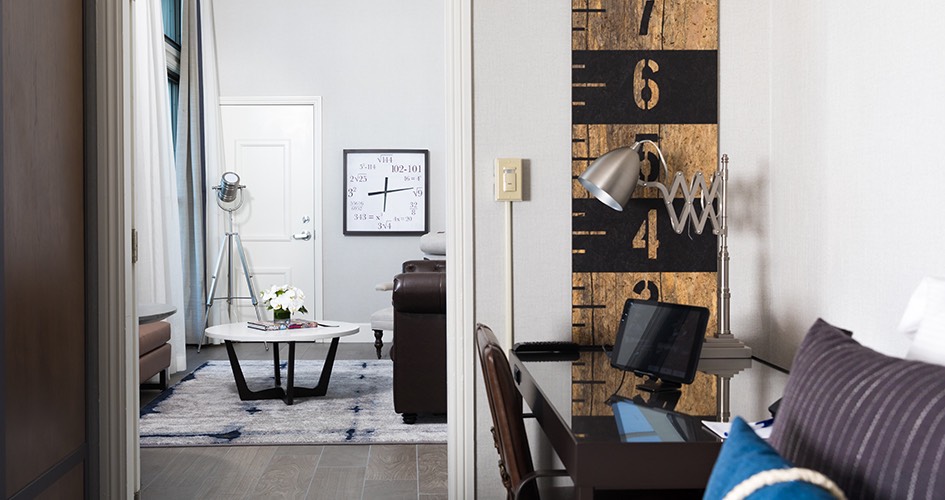 guest room with work desk in foreground and sitting area in backgrund