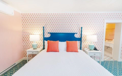 a bed with two lamps on the side