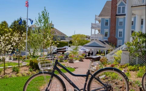 a bicycle parked on a brick path near a building