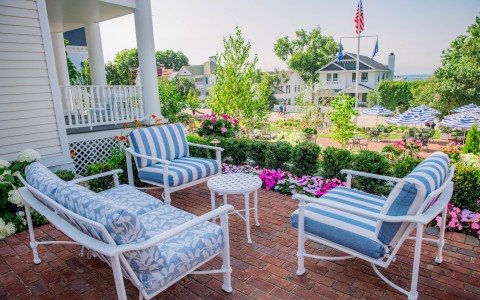 a patio with chairs and a table