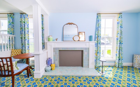 a room with a fireplace and a chair