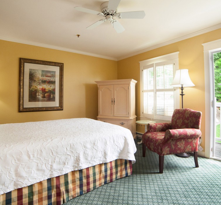 A room with a large white bed and a big window with excellent view