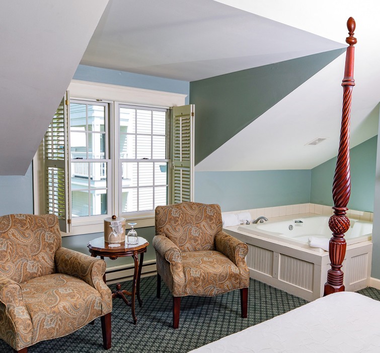 Internal view of a room with two arm chairs and a big window