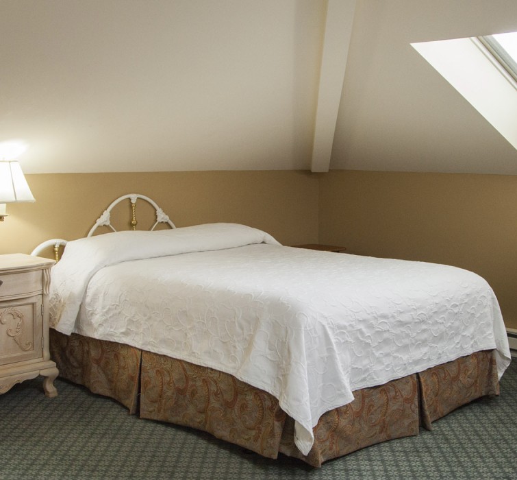 View of a bed with white bed sheets