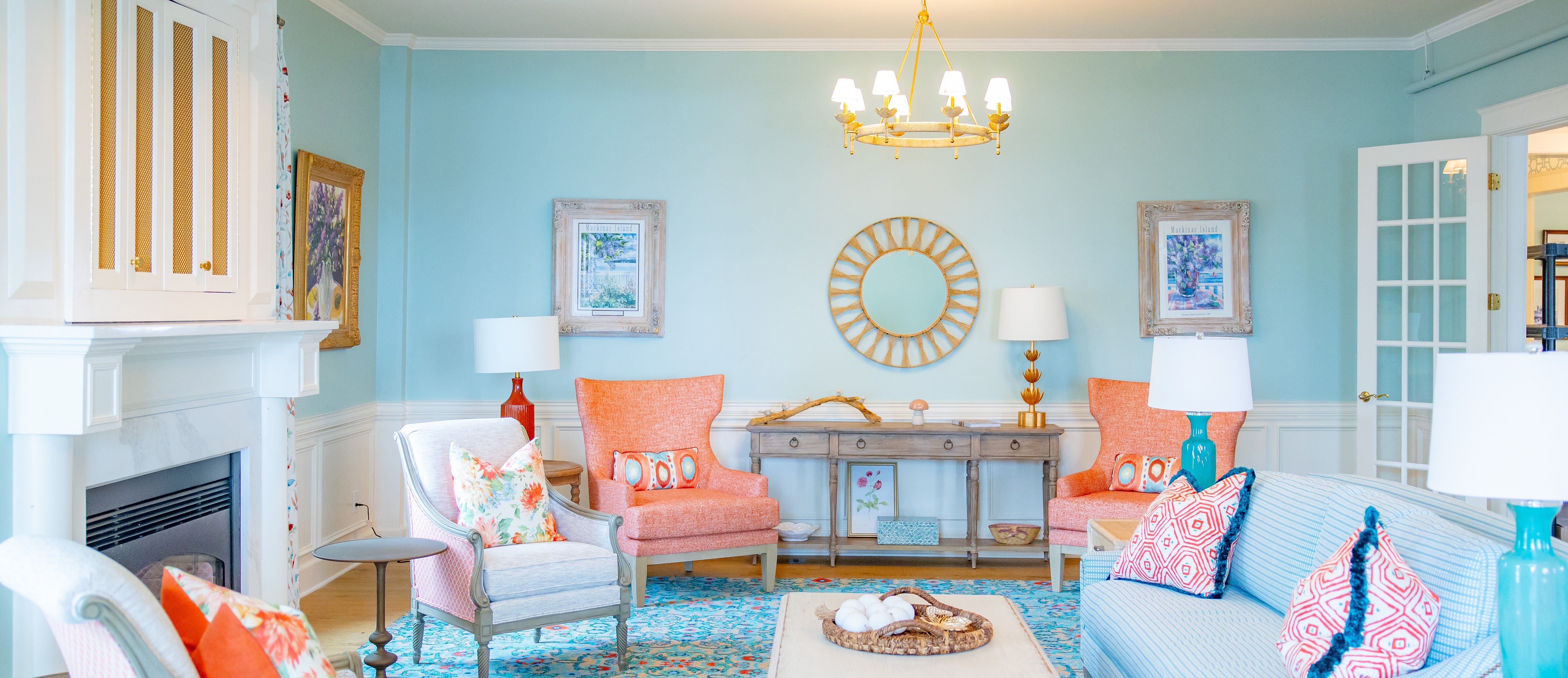 a living room with blue walls and a chandelier