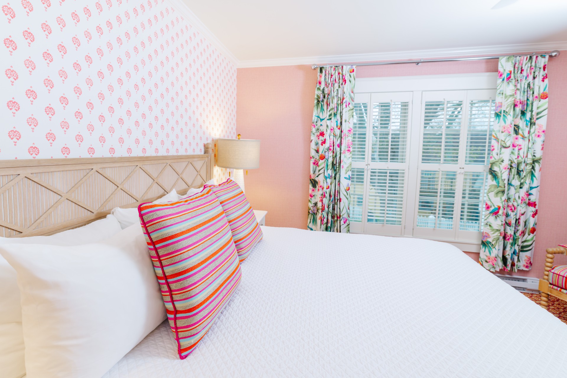 a bed with colorful pillows in a room