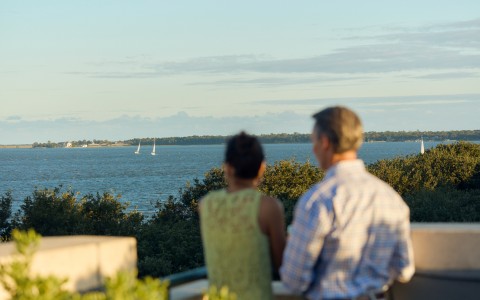 a man and woman looking at a body of water