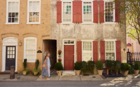 a woman walking in front of a building