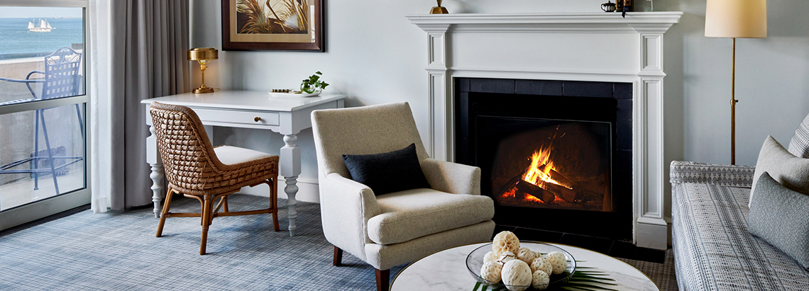 a white chair next to a fireplace