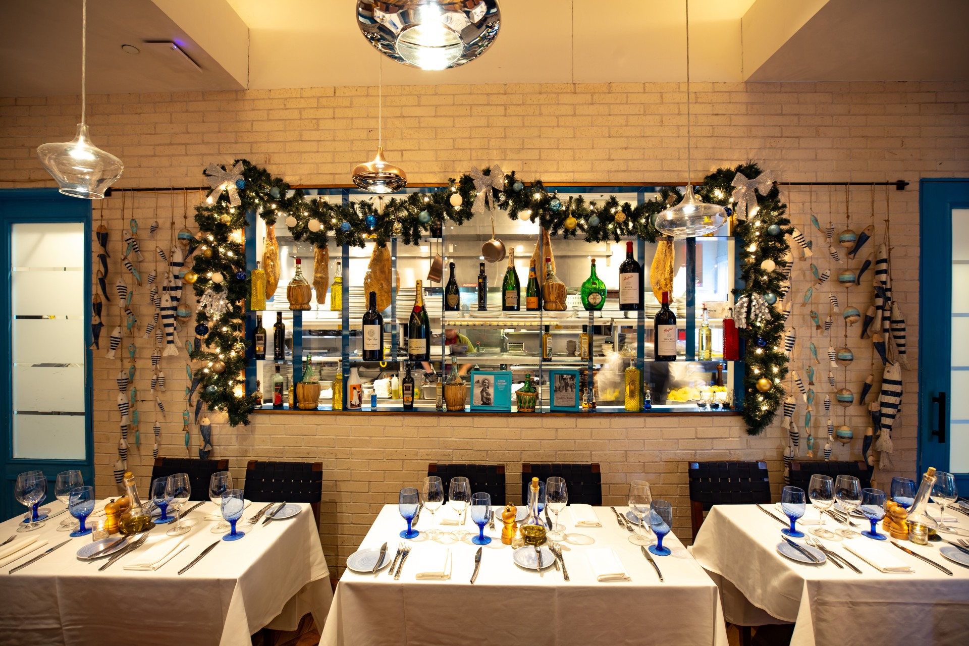 a restaurant with white tables and blue chairs