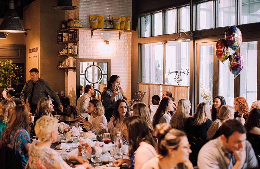 view of a restaurant full of people celebrating 