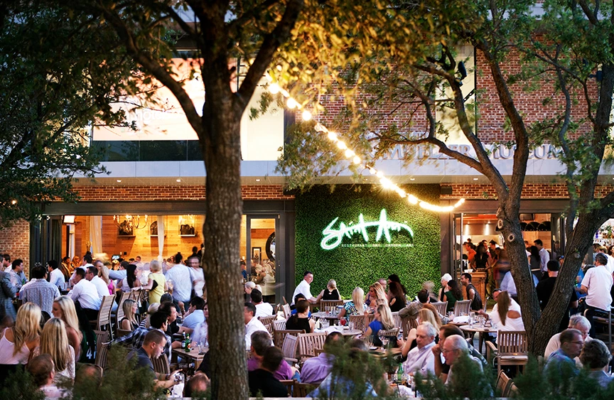 outdoors of a restaurant with all the tables full