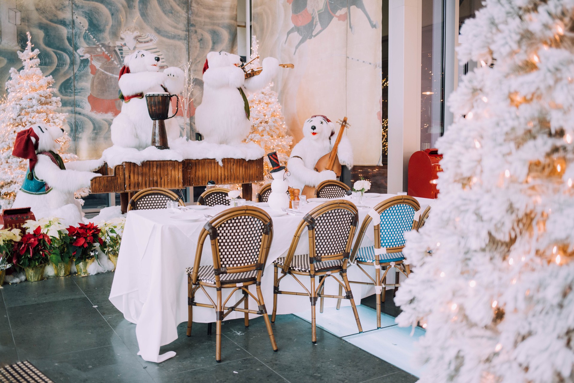 a table with a group of white bears playing instruments