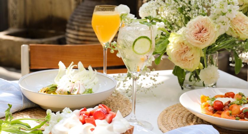 a table with drinks and flowers