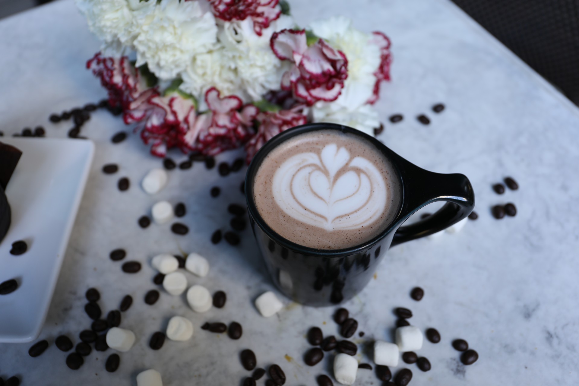 a cup of coffee with a heart design on top