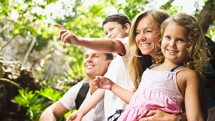 view of a mother and father with their two children