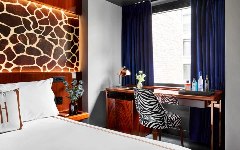 Queen bed with a desk and zebra stamp chair