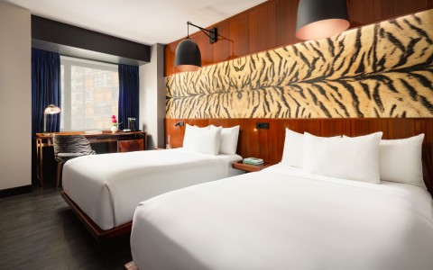 a room with two beds and a desk