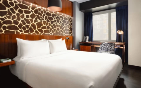 a bed with a chair and a desk