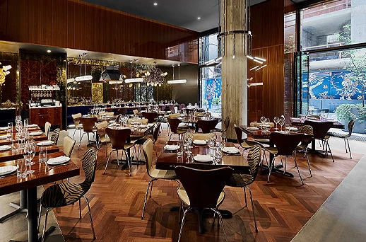 A dining area with multiple tables set for meals.