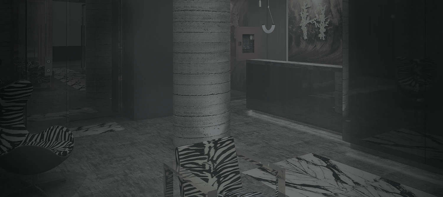 A dimly lit lobby with modern furniture and decor.