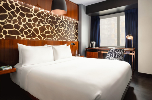 a bed with a chair and a desk