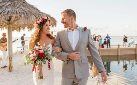 Newly wedding couple walking by the pool