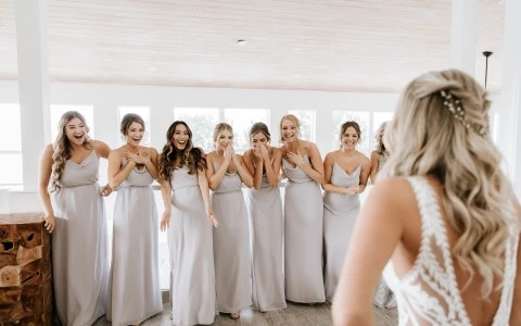 Bridemaids reacting to the bride dress for the first time.