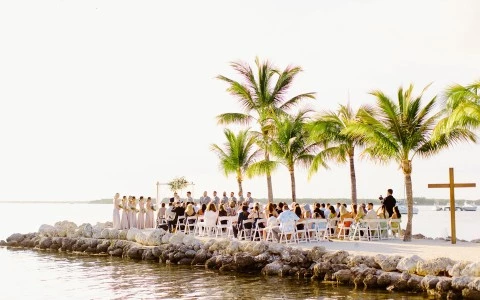 a group of people standing on a dock by a body of water