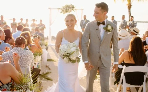 a man and woman walking down a aisle