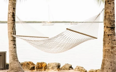 An empty hammock overlooking the ocean.